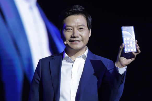 epa07865502 Lei Jun, Founder and CEO of Chinese mobile internet company Xiaomi Technology Co. Ltd., displays the Xiaomi MIX Alpha smartphone during the Xiaomi new 5G smartphone product launch ceremony ...