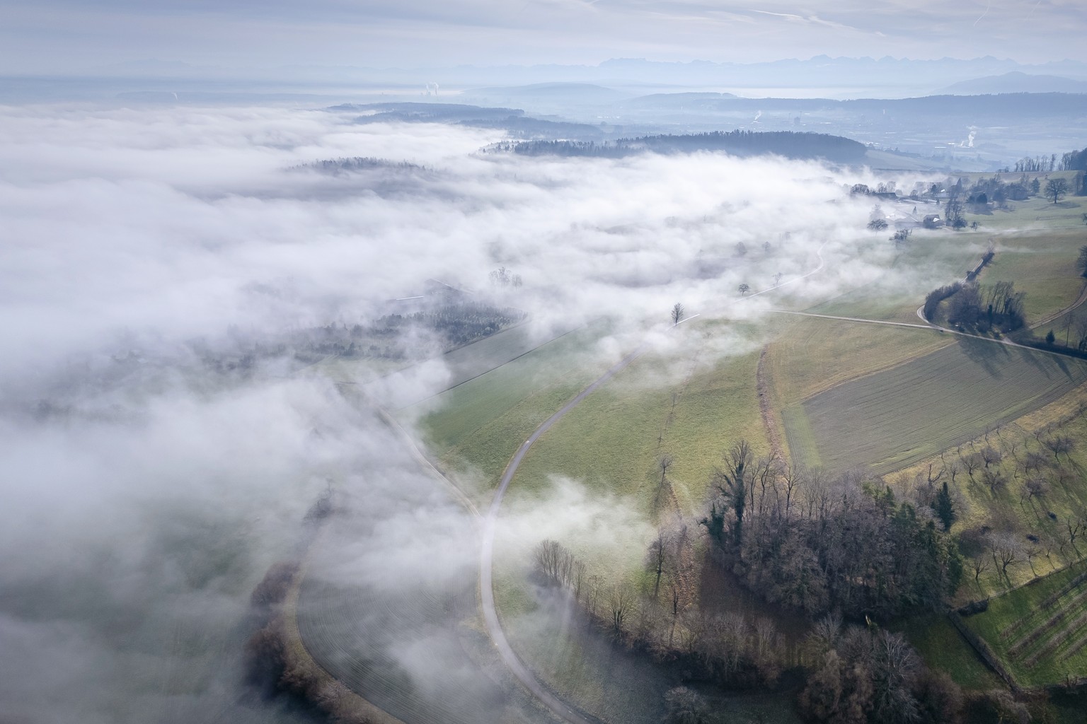A general view shows the landscape around Regensberg in the fog in Regensberg, Switzerland on Tuesday, January 30, 2024. (KEYSTONE/Michael Buholzer)