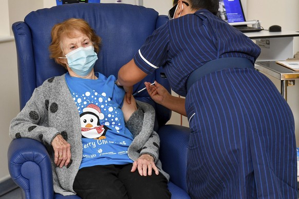 FILE - In this Tuesday Dec. 8, 2020 file photo, 90 year old Margaret Keenan, the first patient in the UK to receive the Pfizer-BioNTech COVID-19 vaccine, administered by nurse May Parsons at Universit ...