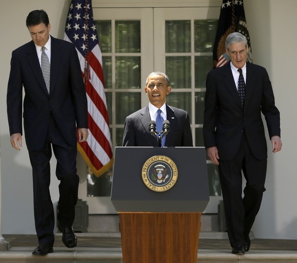 FILE - In this June 21, 2013, file photo, President Barack Obama, followed by outgoing FBI Director Robert Mueller, right, and his choice to succeed Mueller, James Comey, left, walks towards the podiu ...