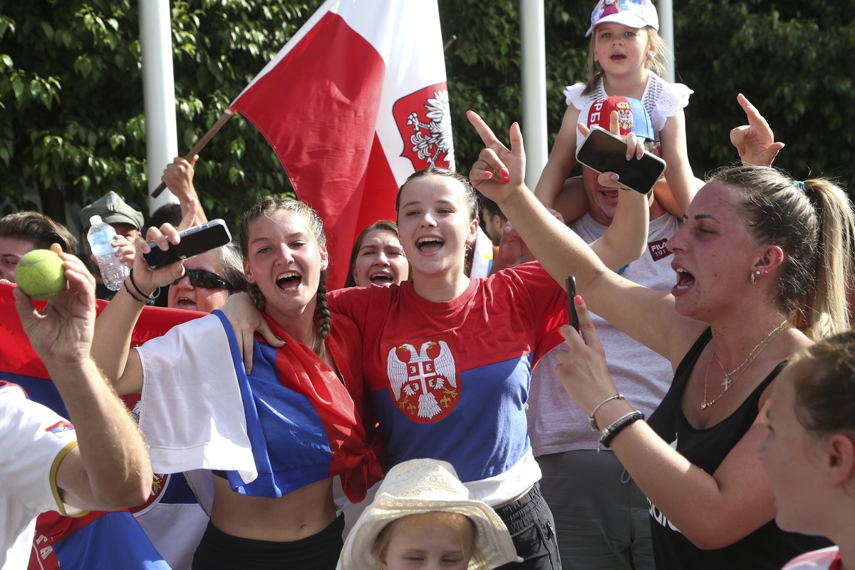 Fans of Serbia's Novak Djokovic react to news of his overturned ruling outside Federal Court ahead of the Australian Open in Melbourne, Australia, Monday, Jan. 10, 2022. An Australian judge has r ...