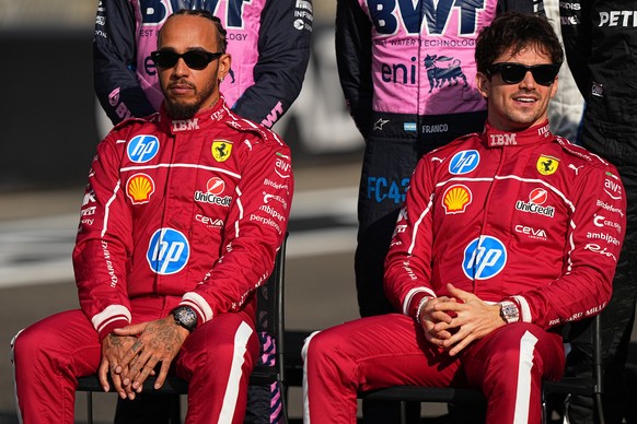 Ferrari driver Lewis Hamilton of Britain, left, and Ferrari driver Charles Leclerc of Monaco attend the drivers parade ahead of the Formula One Abu Dhabi Grand Prix at the Yas Marina Circuit in Abu Dh ...