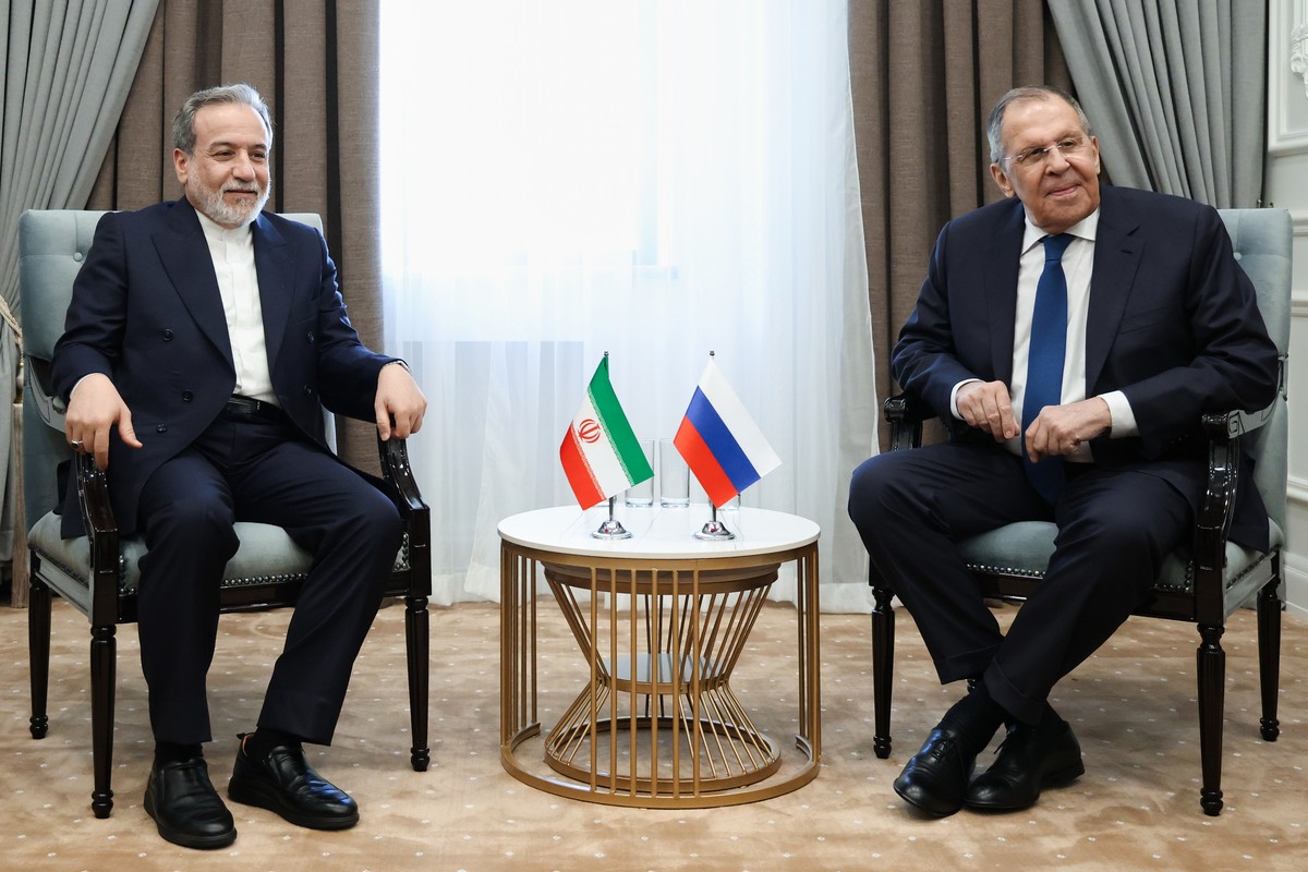 In this photo provided by Russian Foreign Ministry Press Service, Russian Foreign Minister Sergey Lavrov, right, and Iranian Foreign Minister Abbas Araghchi, pose for a photo on the sidelines of a mee ...