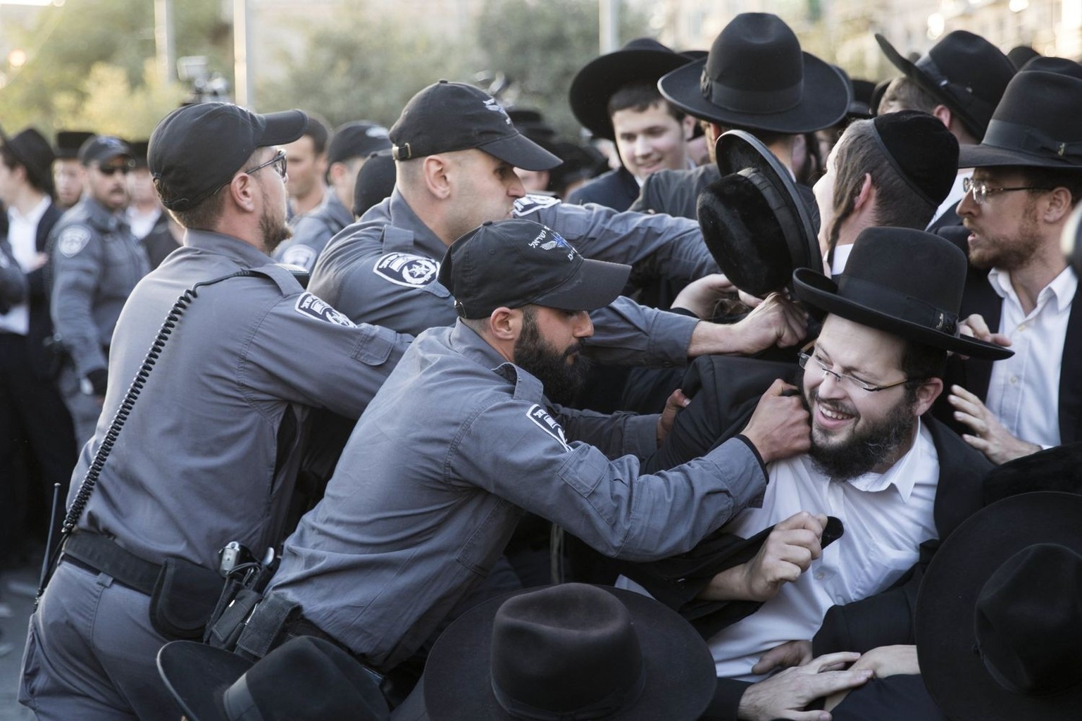 epa06276462 Israeli Border Police clash with Ultra-Orthodox Jewish demonstrators that are blocking the Jerusalem Light Rail track at a main junction, during a protest against army recruitment in Jerus ...