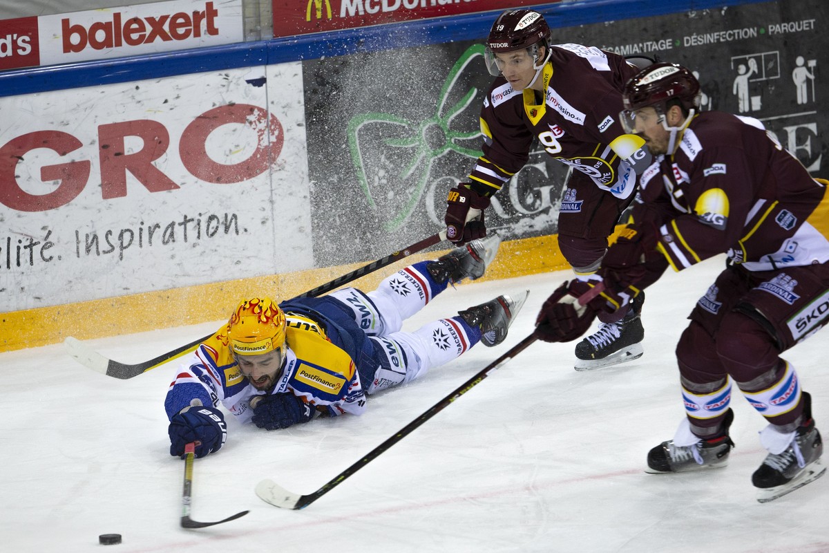 PostFinance Top Scorer Lions' forward Denis Hollenstein, left, vies for the puck with Geneve-Servette's players forward Timothy Kast, center, and defender Arnaud Jacquemet, right, during a N ...