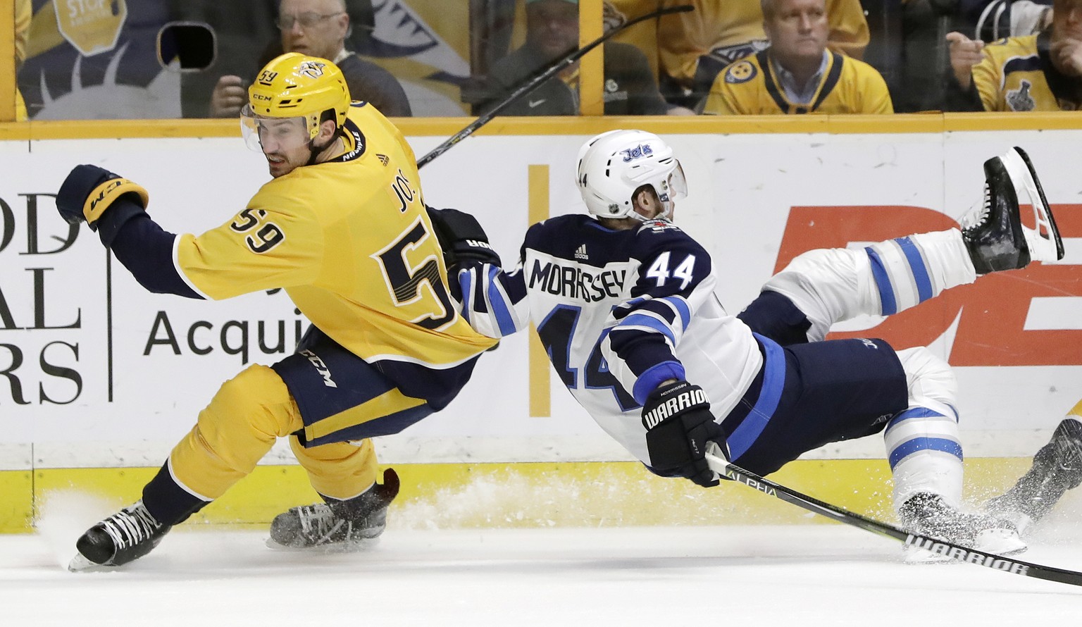 Winnipeg Jets defenseman Josh Morrissey (44) falls as Nashville Predators&#039; Roman Josi (59), of Switzerland, skates past in the first period of an NHL hockey game Tuesday, March 13, 2018, in Nashv ...