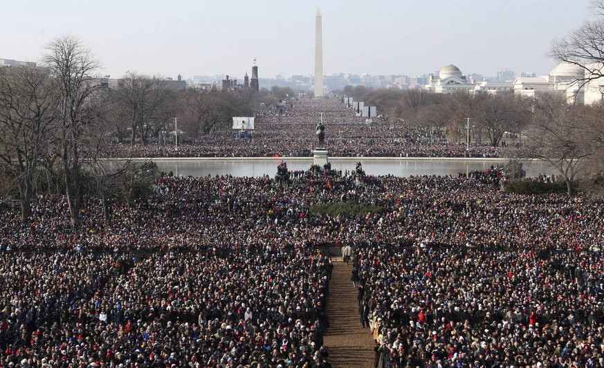 Crowds gather to watch the inauguration of President Barack Obama Tuesday, Jan. 20, 2009, on the west side of the Capitol in Washington. The Washington Monument can be seen in the background. (AP Phot ...