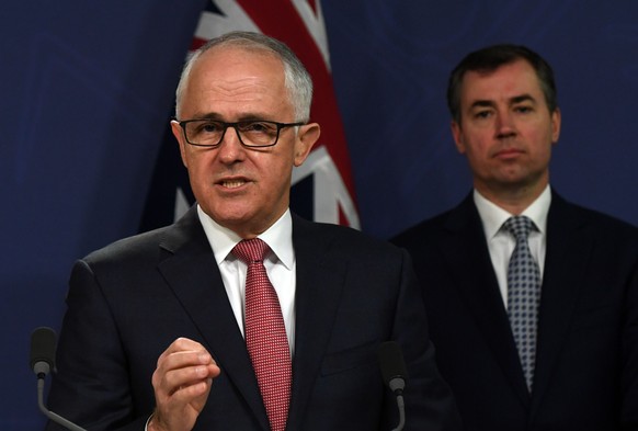 epa06116894 Australian Prime Minister Malcolm Turnbull (L) speaks during an address to the media as Australian Justice Minister Michael Keenan (R) looks on, at the Commonwealth Parliamentary Offices i ...