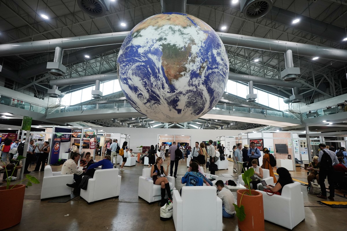 Attendees sit under a globe in a lobby at the side events pavilions at the COP30 U.N. Climate Summit, Tuesday, Nov. 11, 2025, in Belem, Brazil. (AP Photo/Fernando Llano)
Climate COP30