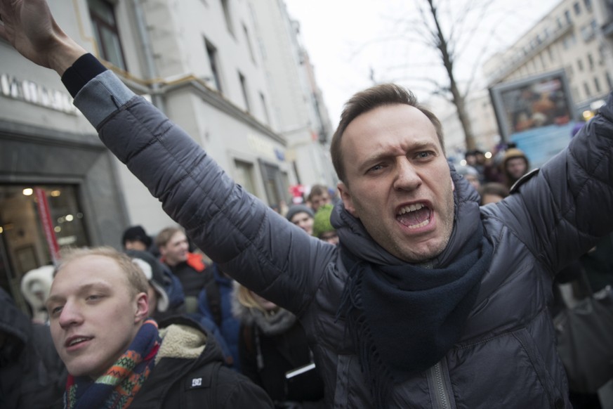 Russian opposition leader Alexei Navalny, centre, attends a rally in Moscow, Russia, Sunday, Jan. 28, 2018. Navalny has been arrested in Moscow while walking with protesters, as protests take place ac ...