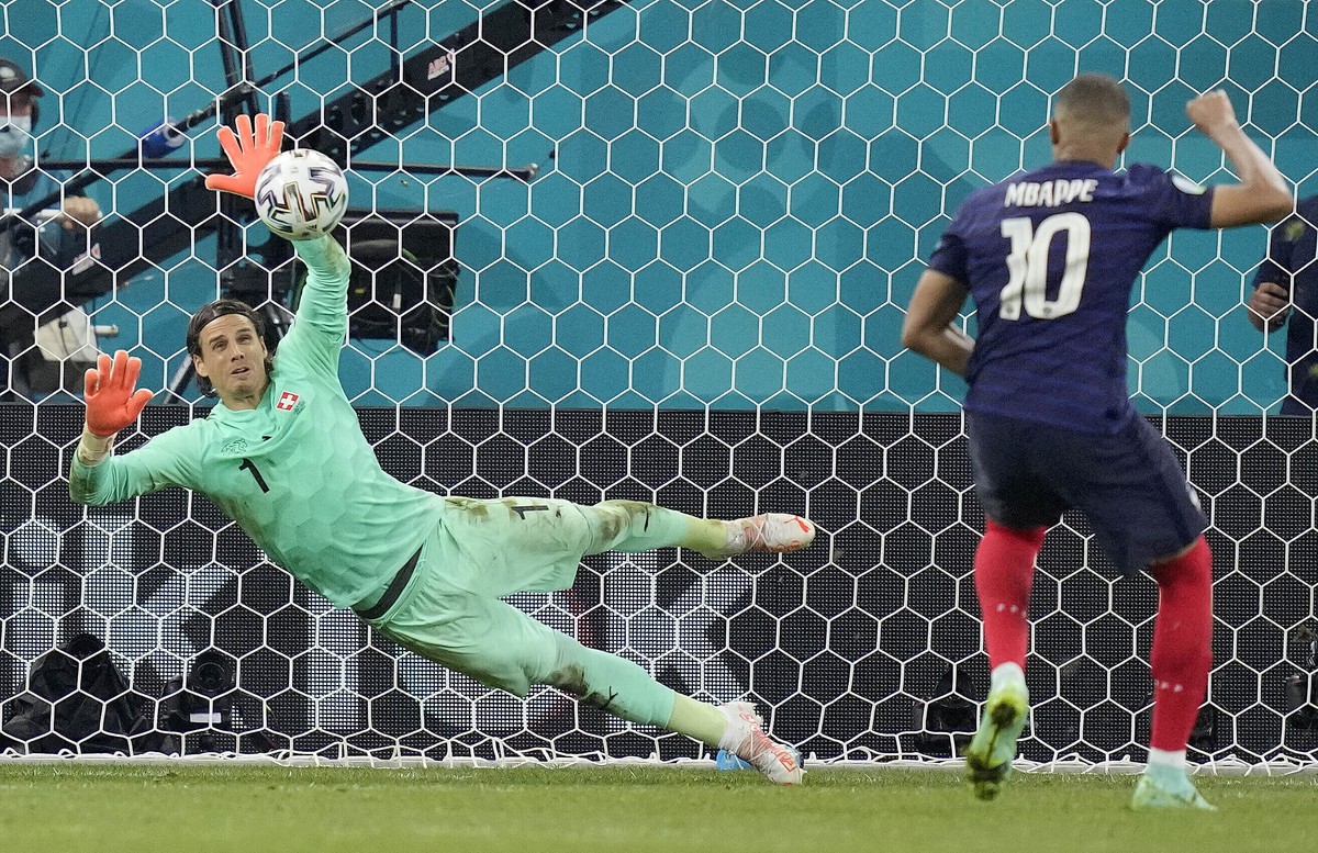 Switzerland's goalkeeper Yann Sommer saves the penalty shot by France's Kylian Mbappe during the Euro 2020 soccer championship round of 16 match between France and Switzerland at the Nationa ...