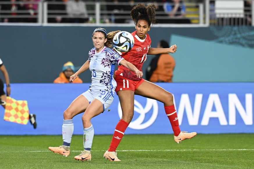 Switzerland's Coumba Sow, right, takes a shot on goal as Spain's Aitana Bonmati watches during the Women's World Cup second round soccer match between Switzerland and Spain at Eden Park ...
