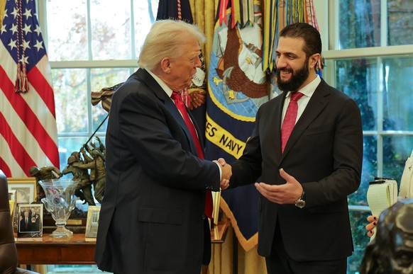 In this photo released by Syrian Presidency press office, President Donald Trump, left, shakes hands with Syria&#039;s President Ahmad al-Sharaa, at the White House in Washington, Monday, Nov. 10, 202 ...