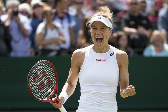 Viktorija Golubic of Switzerland celebrates after winning her first round match against Iga Swiatek of Poland, at the All England Lawn Tennis Championships in Wimbledon, London, on Monday, July 1, 201 ...