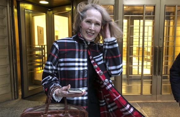 FILE - Columnist E. Jean Carroll leaves federal court, on Feb. 22, 2022, in New York. Former President Donald Trump will have to answer questions under oath next week in a defamation lawsuit lodged by ...