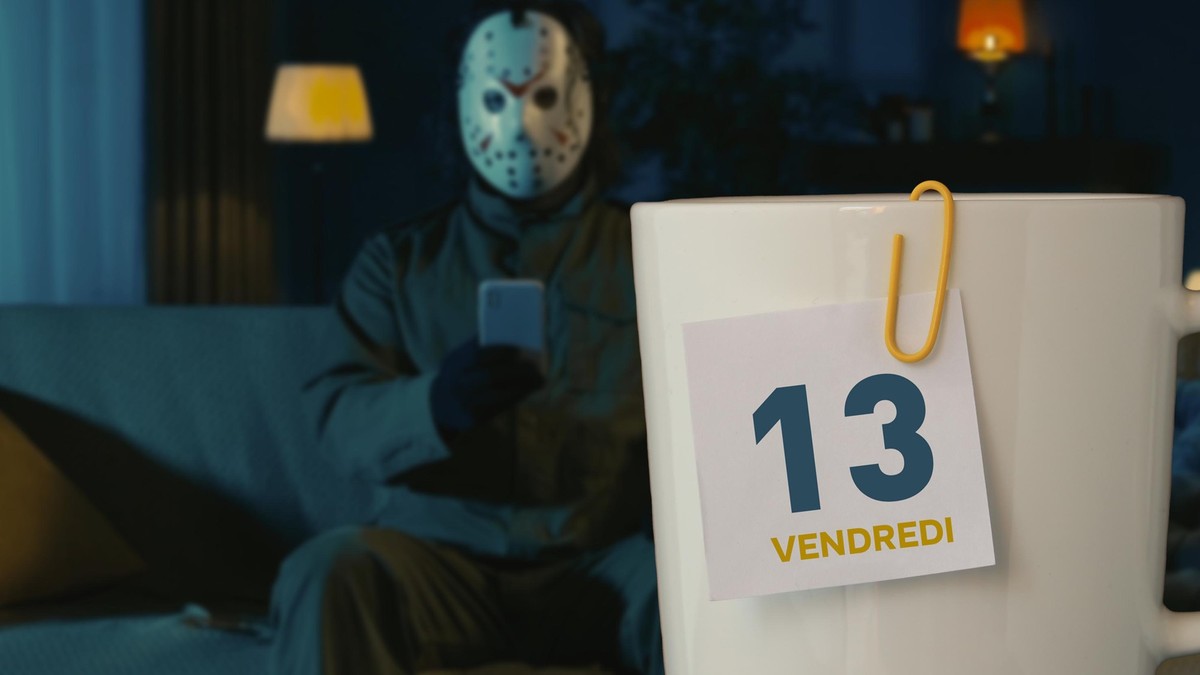 Horror maniac sitting on the sofa in the living room and holding smartphone, watching social media.