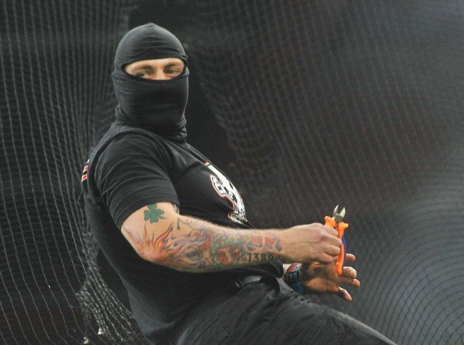 epa02622080 (FILE) A file picture dated 12 October 2010 shows Serbian fan Ivan Bogdanov cutting a protection net before the UEFA EURO 2012 qualification soccer match between Italy and Serbia at the Lu ...