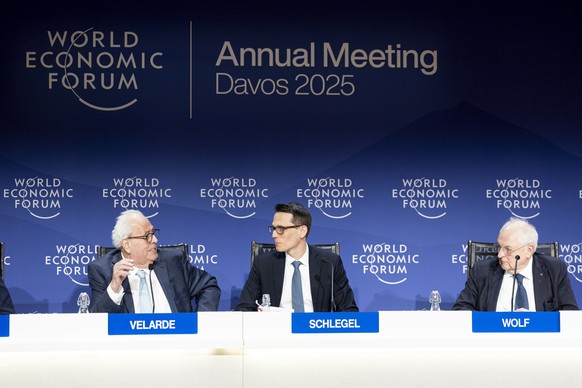 epa11847255 Governor of Central Bank of Peru Julio Velarde (L) speaks next to Martin Schlegel (C), Chairman of the Governing Board of Swiss National Bank (SNB), and Martin Wolf Associate Editor and Ch ...