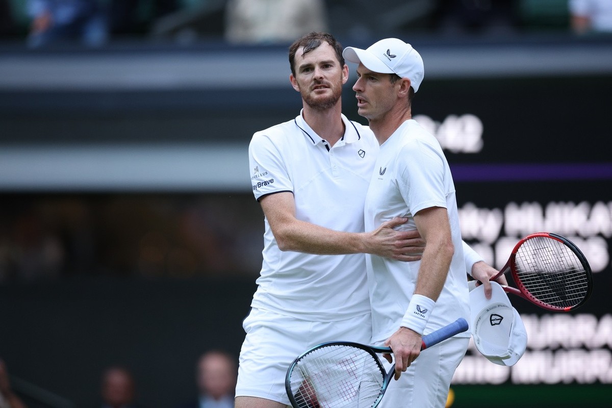 epa11457922 Andy Murray (R) and Jamie Murray (L) of Britain embrace after losing against John Peers and Rinky Hijikata of Australia (both unseen) during their Men's doubles 1st round match at the ...