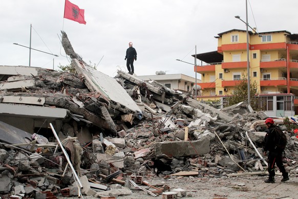 epa08031137 Search and rescue team from Croatia search in the rubble of a building after an earthquake hit Durres, Albania, 28 November 2019. Albania was hit by a 6.4 magnitude earthquake on 26 Novemb ...