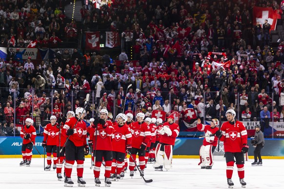 Switzerland's Roman Josi, right, and his teammates celebrate the game winner goal of Dean Kukan, during the overtime of the men's group A preliminary round game between Switzerland and Czech ...