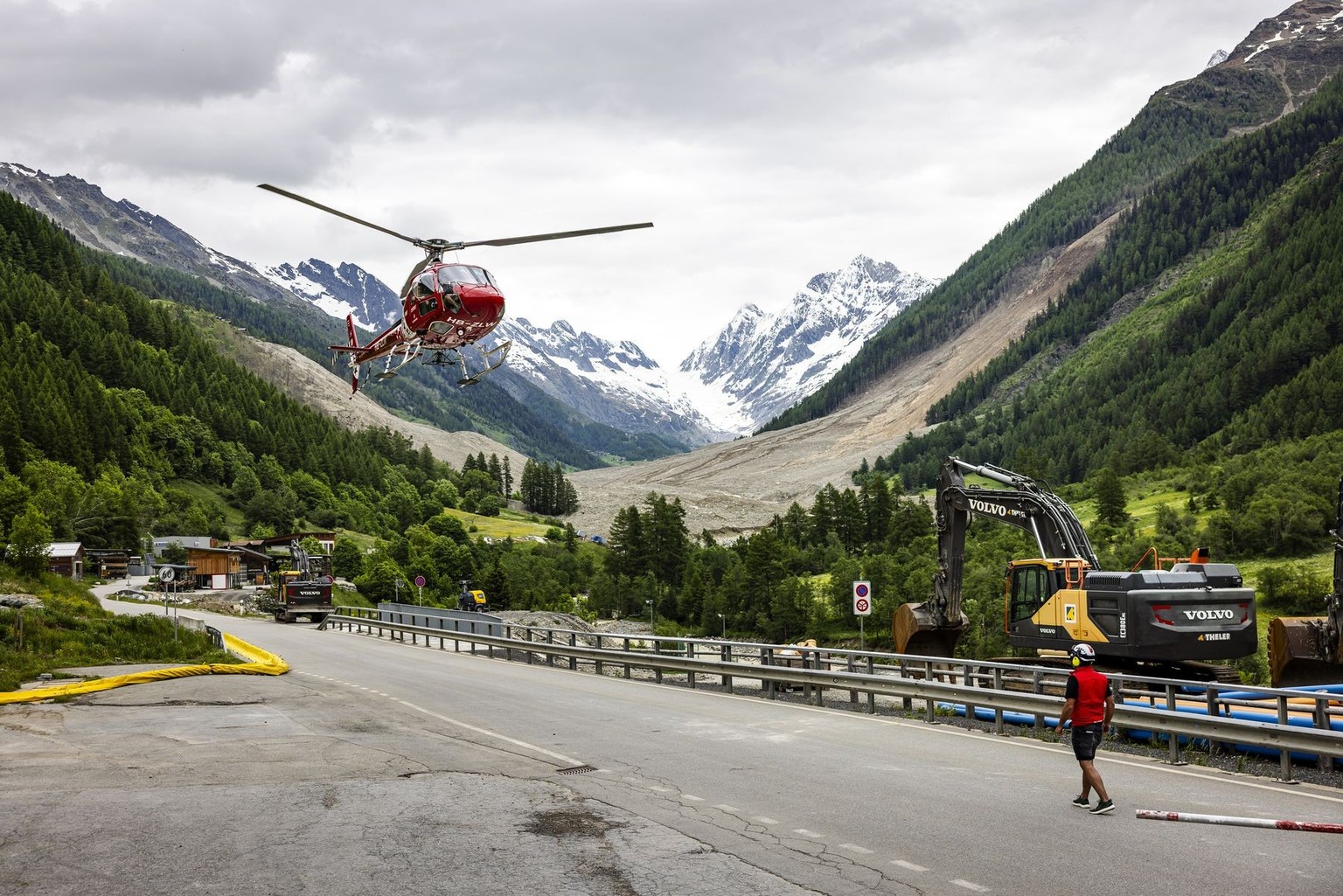 Specialists take off with a helicopter for reconnaissance flights in devastated areas after a massive avalanche, triggered by the collapse of the Birch Glacier, swept down to the valley floor and demo ...