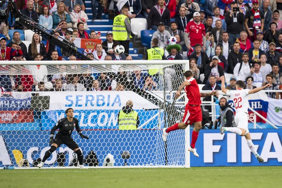 Serbia&#039;s forward Aleksandar Mitrovic, center, scores the first goal, against Switzerland&#039;s goalkeeper Yann Sommer, left, and Switzerland&#039;s defender Fabian Schaer, right, during the FIFA ...