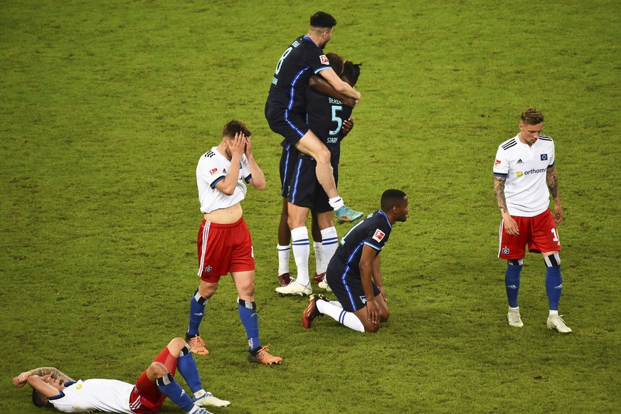 Players react after the German Bundesliga relegation/promotion playoff soccer match between Hamburger SV and Hertha Berlin at the Volksparkstadion in Hamburg, Germany, Monday, May 23, 2022. Hertha Ber ...