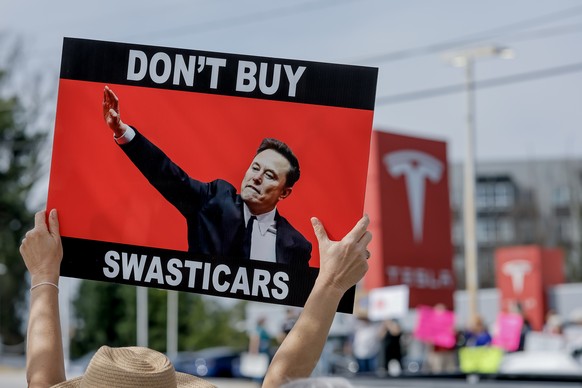 epa11949905 Demonstrators gather outside a Tesla dealership to protest businessman Elon Musk&#039;s current role in US President Donald Trump&#039;s administration in Decatur, Georgia, USA, 08 March 2 ...