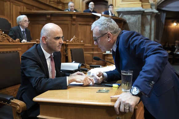 Bundesrat Alain Berset, links, diskutiert mit Ruedi Noser, FDP-ZH, waehrend der Debatte um die Ueberbrueckungsleistung fuer aeltere Arbeitslose, waehrend der Wintersession der Eidgenoessischen Raete,  ...