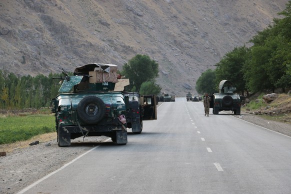 Afghan soldiers pause on a road at the front line of fighting between Taliban and Security forces, near the city of Badakhshan, northern Afghanistan, Sunday, July. 4, 2021. Officials said Sunday that  ...
