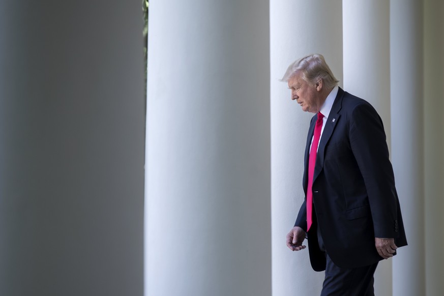 epaselect epa06004455 US President Donald J. Trump walks from the Oval Office to announces that the US is withdrawing from the Paris climate accord during a Rose Garden event at the White House in Was ...