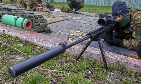 epa10582179 A member of the newly formed &#039;Spartan&#039; brigade looks through a sniper scope during military training on a shooting range near Kharkiv, northeastern Ukraine, 20 April 2023, amid t ...