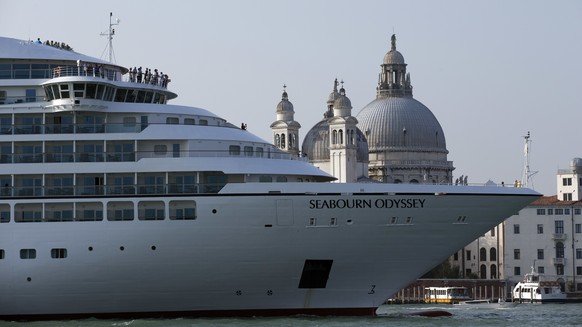 FILE-- In this Sept. 27, 2014 file photo a cruise ship transits in the Giudecca canal in front of St. Mark&#039;s Square, in Venice, Italy. Declaring Venice&#039;s waterways a