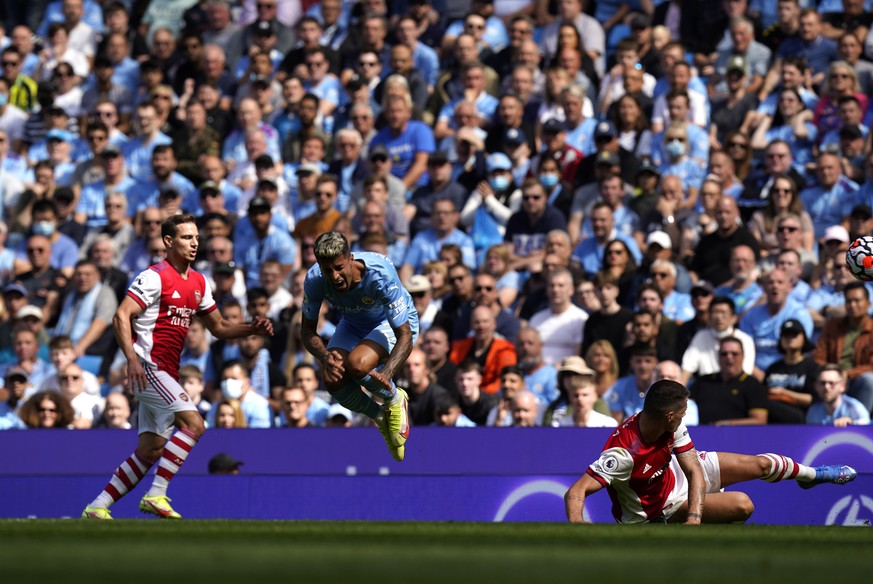 epa09433662 Joao Cancelo (C) of Manchester City is tackled by Granit Xhaka (R) of Arsenal during the English Premier League match between Manchester City and Arsenal London in Manchester, Britain, 28  ...