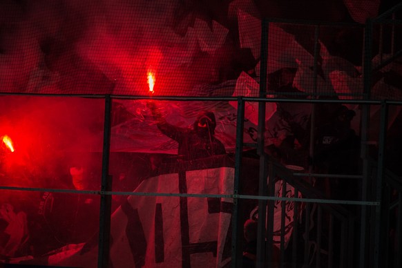 A fan of Lausanne with a flare during the preliminary round game of the National League between HC Ambri-Piotta and Lausanne HC, at the ice stadium Valascia in Ambri, on Sunday, January 14, 2018. (KEY ...