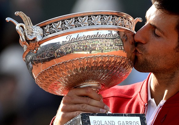 epa05347617 Novak Djokovic of Serbia poses with the trophy after winning against Andy Murray of Britain their men&#039;s single final match at the French Open tennis tournament at Roland Garros in Par ...