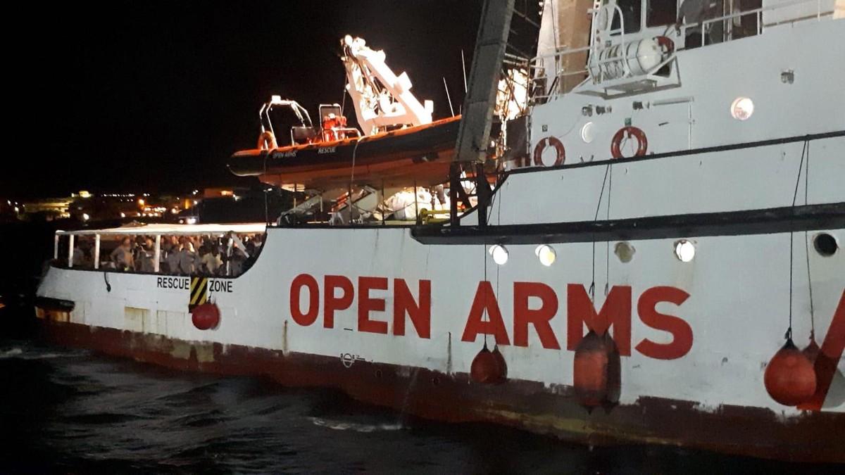 epa07783101 The Spanish humanitarian ship 'Open Arms', with migrants on board, arrives in Lampedusa island, southern Italy, 20 August 2019. An Italian public prosecutor has ordered the confi ...