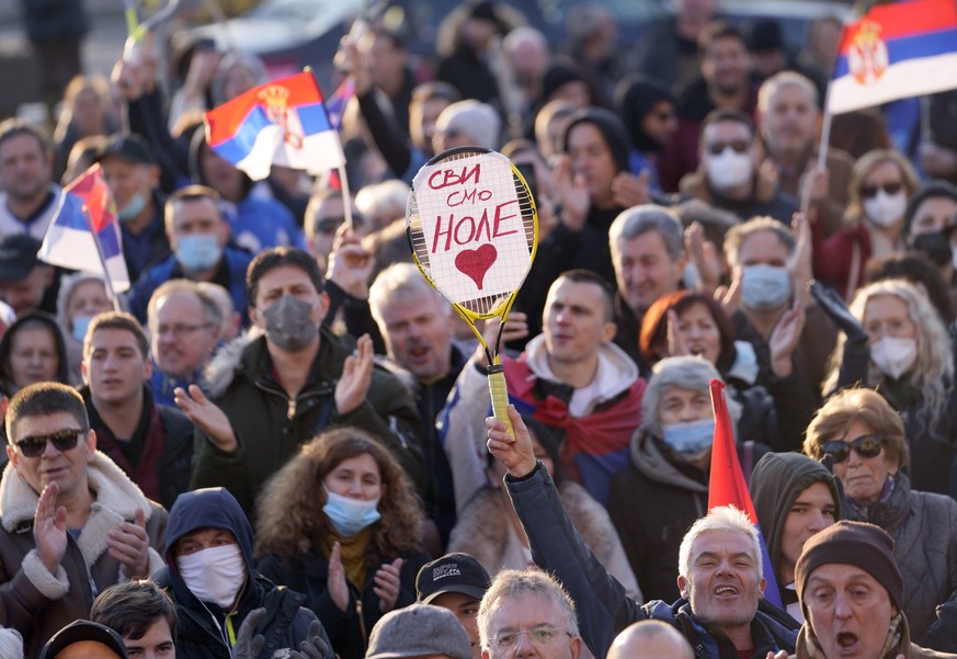 A supporter of Serbia&#039;s Novak Djokovic holds a banner that reads: &#039;&#039;We all are Nole (Novak)&#039;&#039; during protest in Belgrade, Serbia, Friday, Jan. 7, 2022. Several hundred people  ...