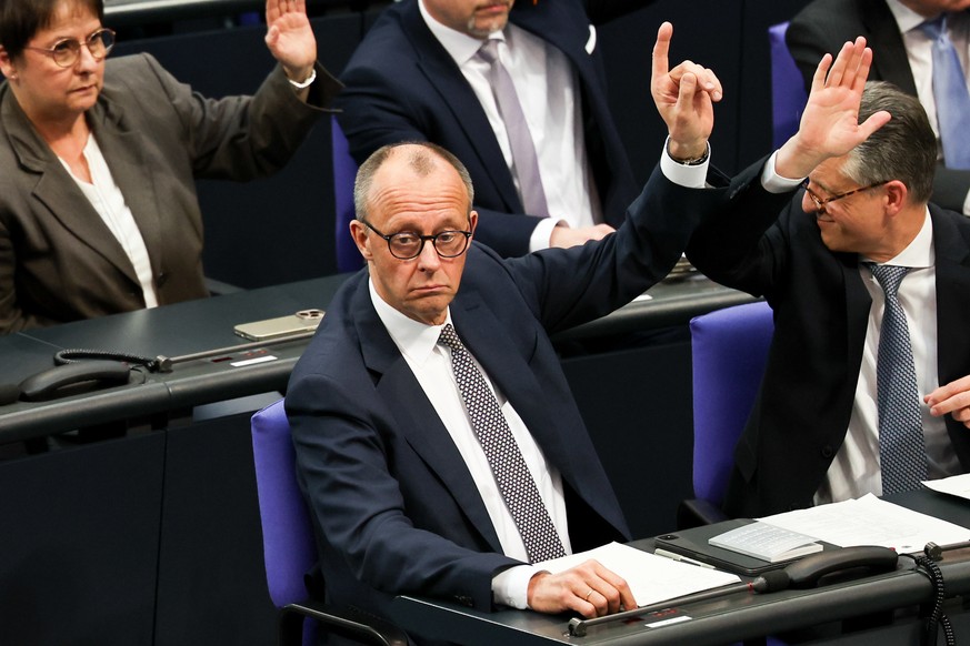 epa11972176 Christian Democratic Union (CDU) party and faction chairman Friedrich Merz (C) reacts during a special plenary session of the German parliament &#039;Bundestag&#039;, in Berlin, Germany, 1 ...