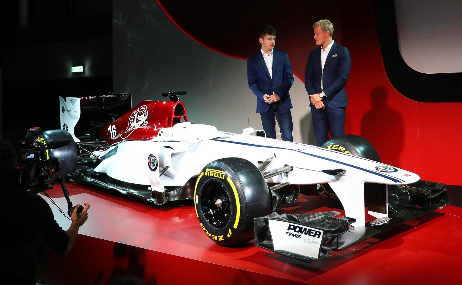 epa06363226 Swedish Formula One driver Marcus Ericsson (R) and his teammate Charles Leclerc (L) of Monaco pose for photographers during the presentation of the Alfa Romeo Sauber F1 Team at Museo Stori ...