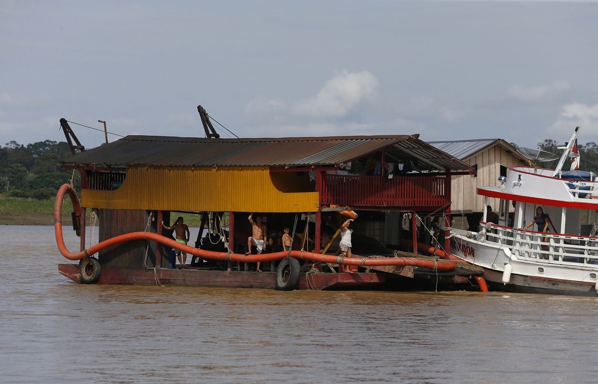 A dredging barge operated by illegal miners searching for gold navigates the Madeira River, in Nova Olinda, Amazonas state, Brazil, Friday, Nov. 26, 2021. Hundreds of barges of illegal gold miners are ...