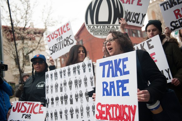 epa06657281 Protestors demonstrate outside of the Montgomery County Courthouse after the arrival of US entertainer Bill Cosby for the first day of his retrial regarding charges stemming from an allege ...