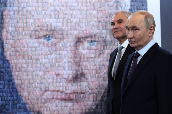 Russian President Vladimir Putin, right, and Russian State Duma Chairman Vyacheslav Volodin visit an exhibition dedicated to 80th birth anniversary of late Russian Liberal Democratic Party leader Vlad ...