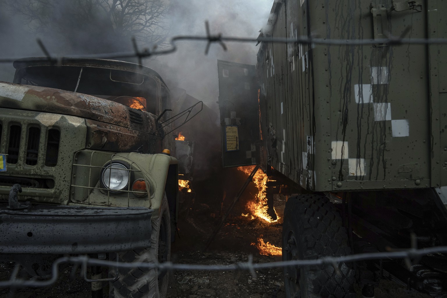Ukrainian military track burns at an air defence base in the aftermath of an apparent Russian strike in Mariupol, Ukraine, Thursday, Feb. 24, 2022. Russian troops have launched their anticipated attac ...