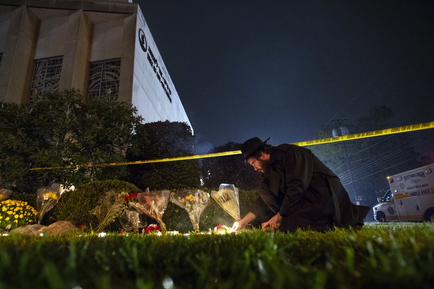 In this Oct. 27, 2018 photo, Rabbi Eli Wilansky lights a candle after a mass shooting at Tree of Life Synagogue in Pittsburgh&#039;s Squirrel Hill neighborhood. Robert Bowers, the suspect in Saturday& ...