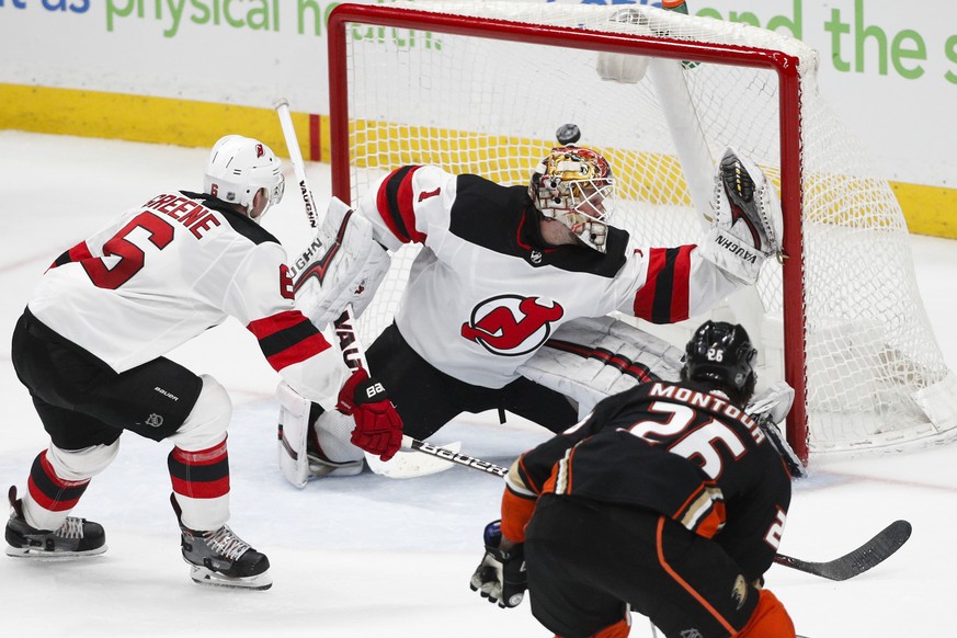 Anaheim Ducks&#039; Brandon Montour, foreground, scores against New Jersey Devils goaltender Keith Kinkaid during the third period of an NHL hockey game Sunday, March 18, 2018, in Anaheim, Calif. The  ...