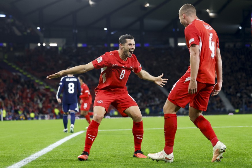 Switzerland's Nico Elvedi, right, celebrates the 0 - 2 goal with Switzerland's Remo Freuler, left, during the UEFA Nations League soccer match between Scotland and Switzerland at the Hampden ...