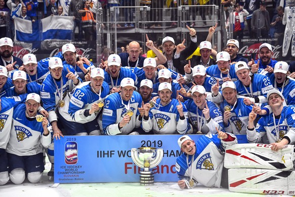 epa07604295 Players of Finland pose with the trophy after winning the IIHF World Championship ice hockey final between Canada and Finland at the Ondrej Nepela Arena in Bratislava, Slovakia, 26 May 201 ...