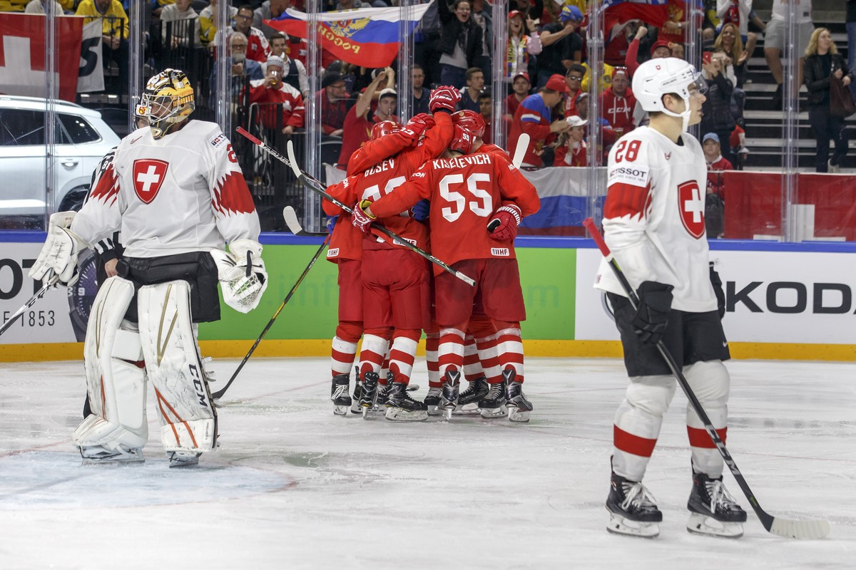 Russia's players celebrate their first goal past Switzerland's goaltender Reto Berra, left, and Switzerland's forward Timo Meier, right, during the IIHF 2018 World Championship prelimin ...